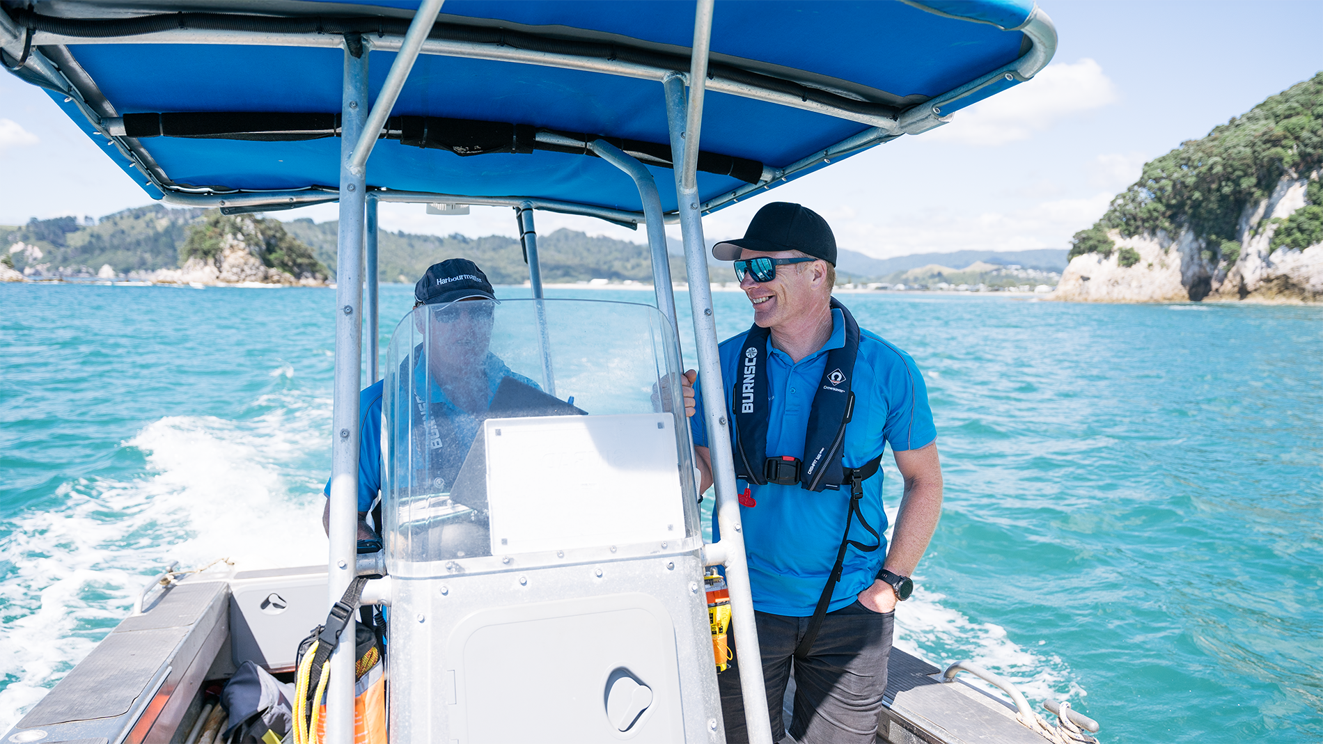 Image of two men on a boat wearing life jackets