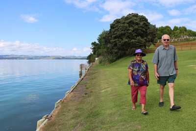 Horahaere Daisy Scott and Ray Montgomery walk along the seawall that protects Maketū Marae from the sea.