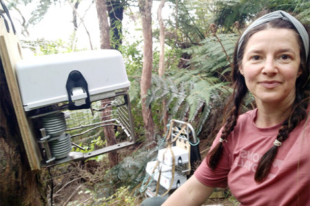 Peri Mawson next to a MEG pest trap in the bush