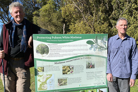 Anthony and Dennis with an information sign in Pukawa Bay