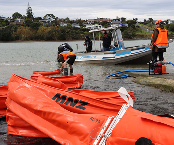 Preparing the boom to be towed out by boat.