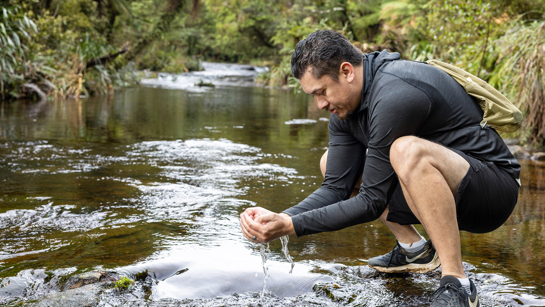 Photo of man in stream near Wairere Falls