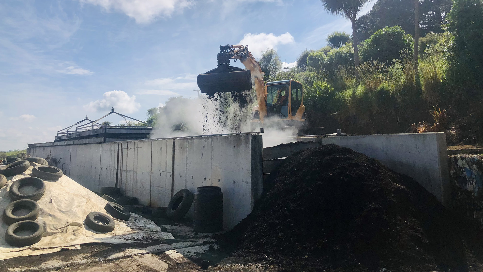 Image of a digger sifting through waste