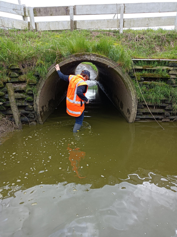 Image of a person standing in a flooded underpass