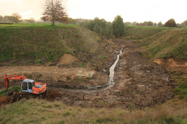 Digger and damaged stream.