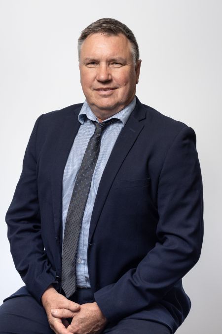 Photo of Warren Maher sitting on chair